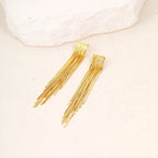 Pendientes llamativos con borlas doradas y brillantes: elegante diseño largo para mujer