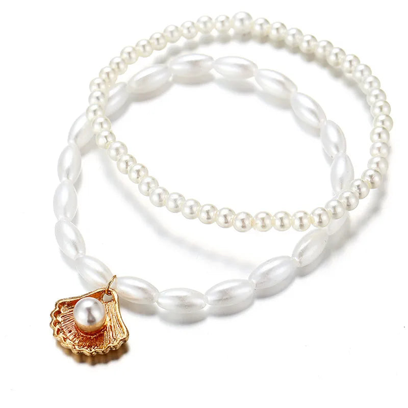 Elegant boho anklet with pearls and shell charm – perfect for beach, weddings, and everyday style.