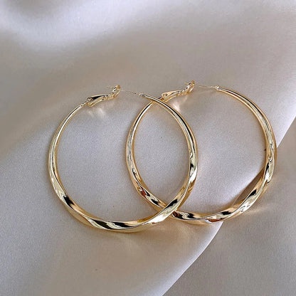 Mobius Twist Gold Hoop Earrings – Classic 50mm Statement Hoops for Women